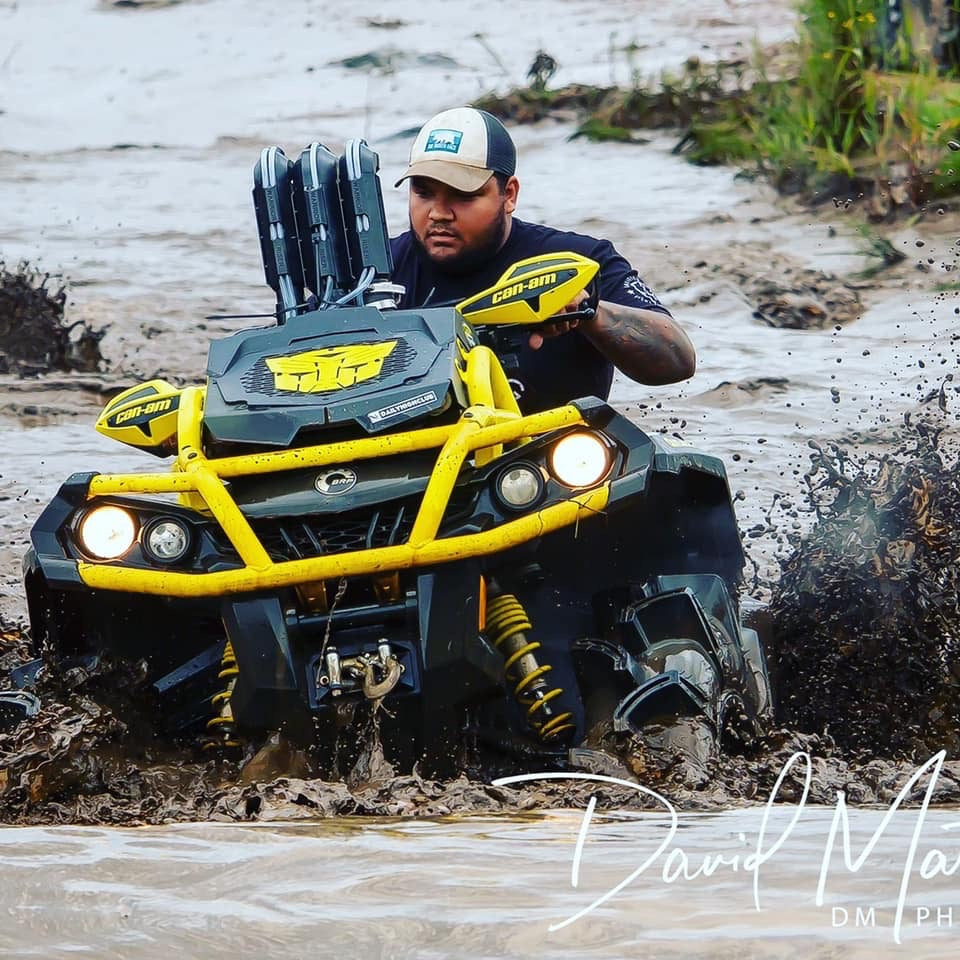 Yellow Transformers Lucky 7 radiator relocate cover on a Can-Am Outlander MAX XMR in the mud