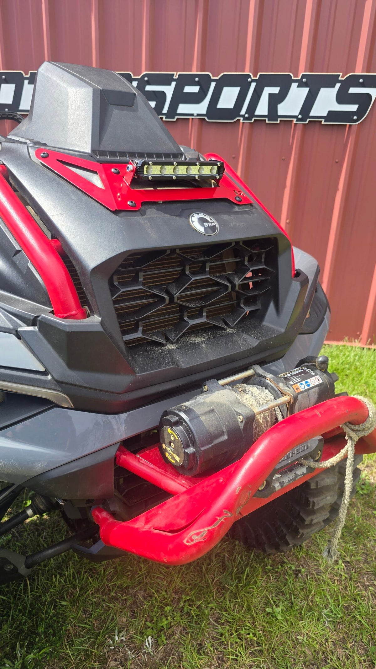 Lucky 7 2025 Can-Am Outlander XMR Gen 3 radiator cover LED Light Bar Legion Red installed on the machine