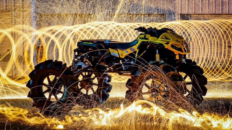 Yellow Can-Am Outlander with Lucky 7 Motorsports custom parts, night long-exposure photo