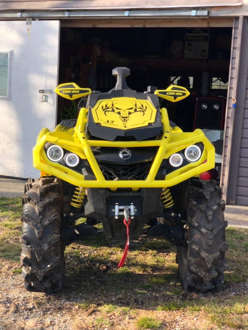Front view of a yellow Deer Skull Punisher Lucky 7 radiator relocate cover on an Outlander MAX XMR