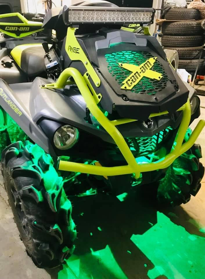 Close-up of a manta green Can-Am X Lucky 7 radiator relocate cover on an Outlander MAX XMR
