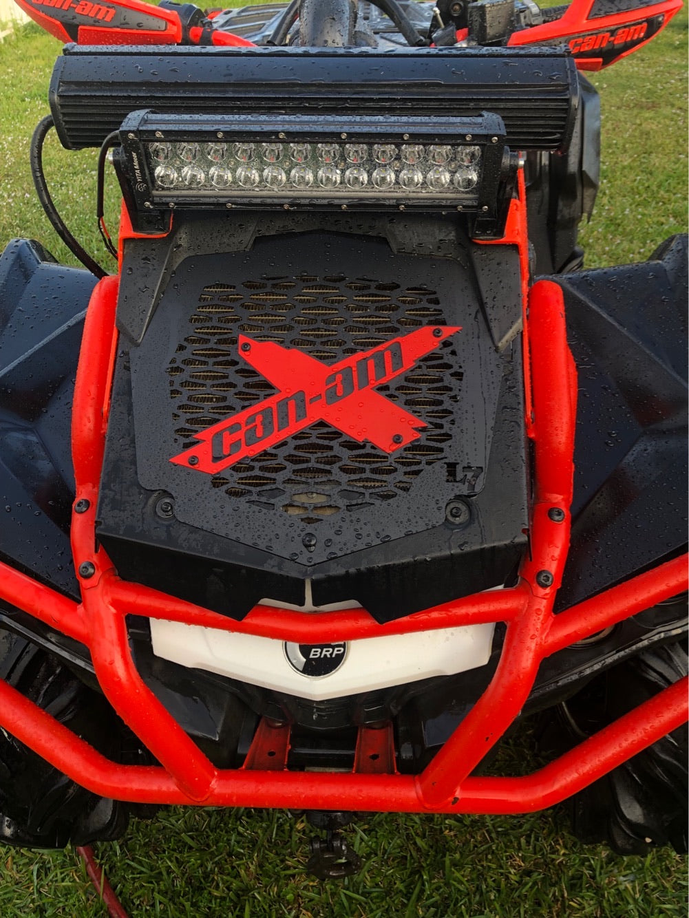 Red Can-Am X Lucky 7 radiator relocate cover on an Outlander MAX XMR