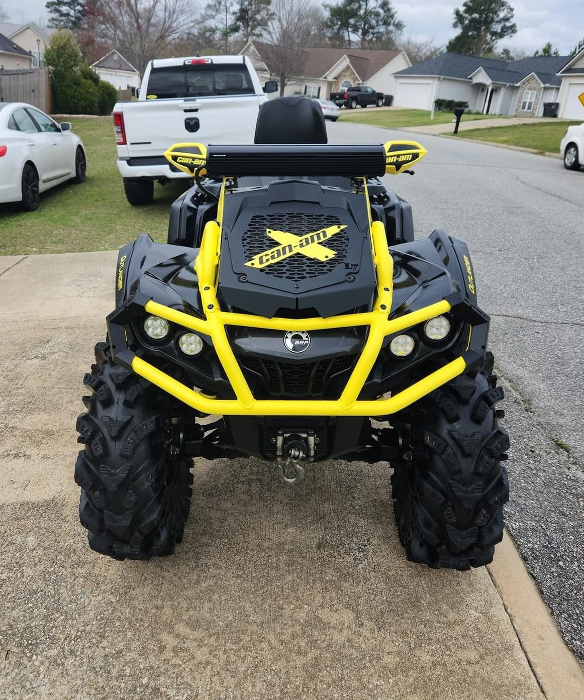 Yellow Can-Am X Lucky 7 radiator relocate cover on a black Outlander MAX XMR