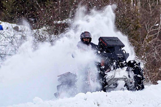Can-Am Renegade XMR in the snow with a Lucky 7 radiator relocate bumper