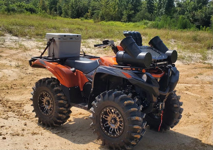 Front view of an orange Yamaha Grizzly with Lucky 7 high-clearance floorboards