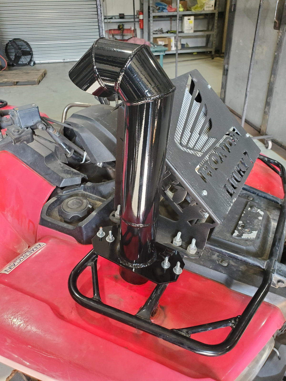 Side view of Lucky 7 aluminum snorkel kit on a Honda Foreman