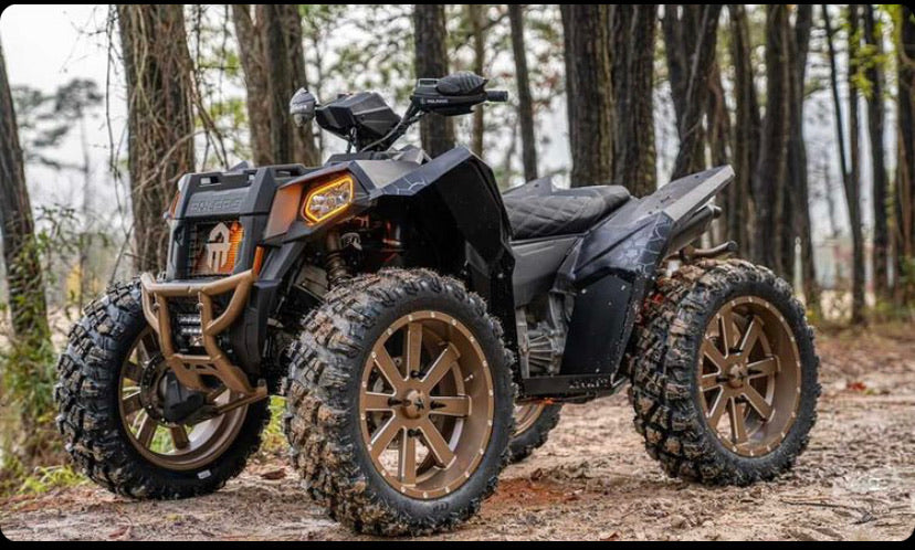 Polaris Scrambler in the woods with Lucky 7 metal floorboards