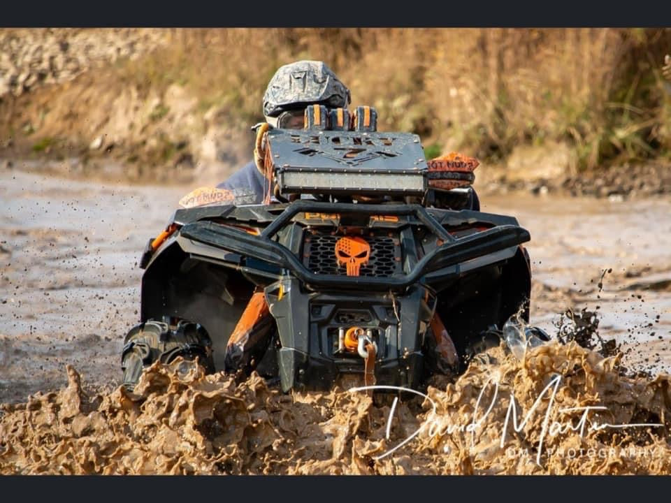 Lucky 7 radiator relocate kit on a Polaris Sportsman in the mud