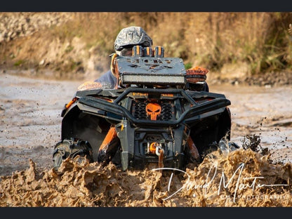 Lucky 7 radiator relocate kit on a Polaris Sportsman in the mud
