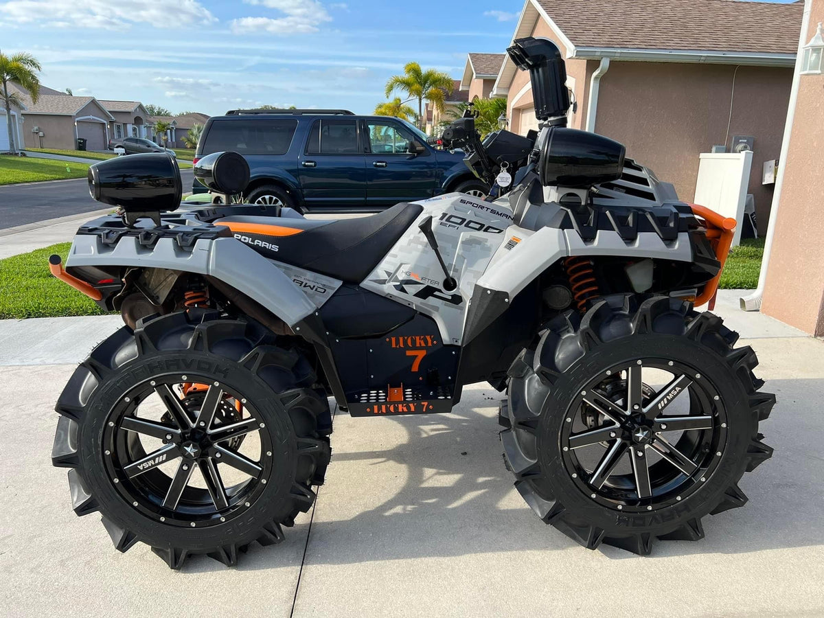 White Sportsman High Lifter 1000 with Lucky 7 floorboards and orange accents