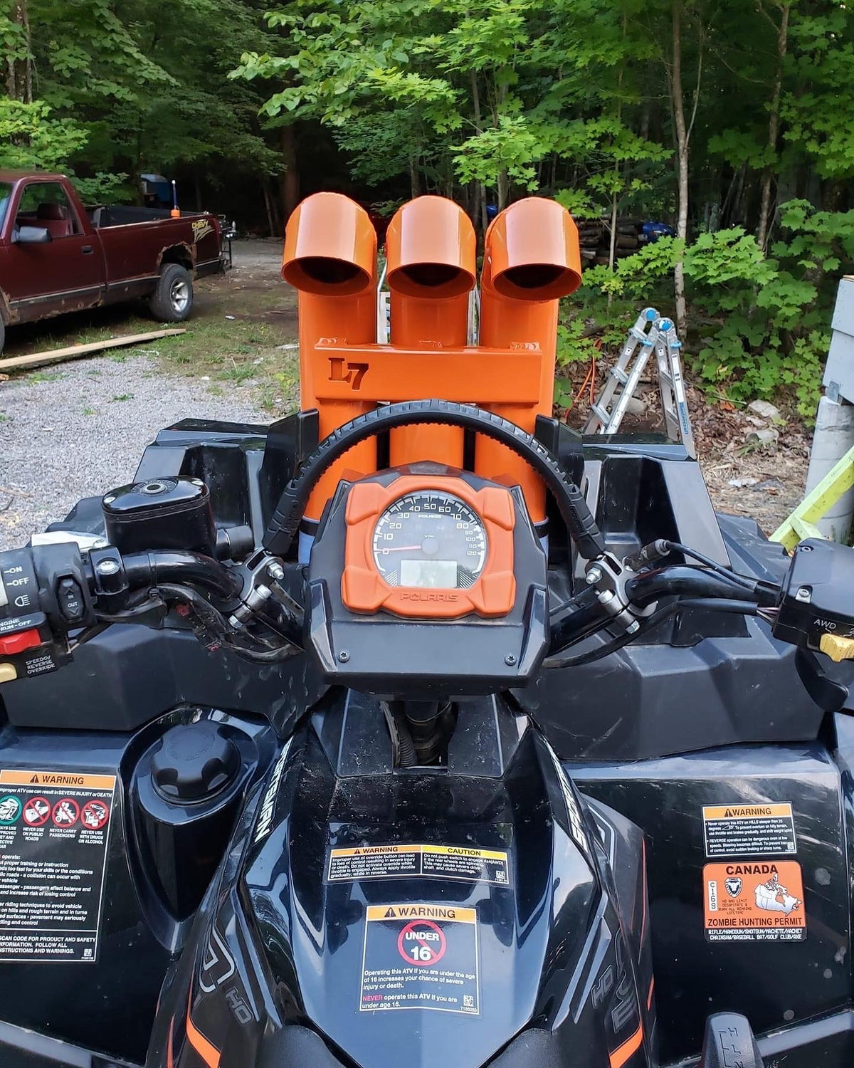 Orange Lucky 7 3 inch aluminum snorkel riser kit on a Polaris Sportsman High Lifter