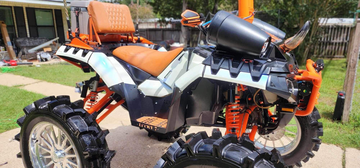 Side view of Lucky 7 metal floorboards on a Sportsman High Lifter