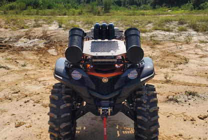 Lucky 7 Yamaha Grizzly Kodiak low profile mesh radiator relocation kit installed on a Grizzly in the mud