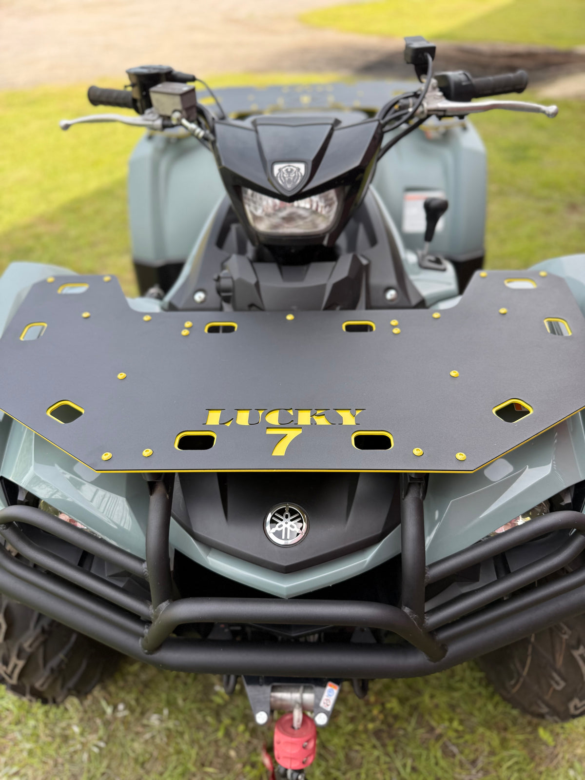 Close-up of Lucky 7 Motorsports front rack on Yamaha Kodiak 450 - black powder coat with yellow LUCKY 7 lettering and accents